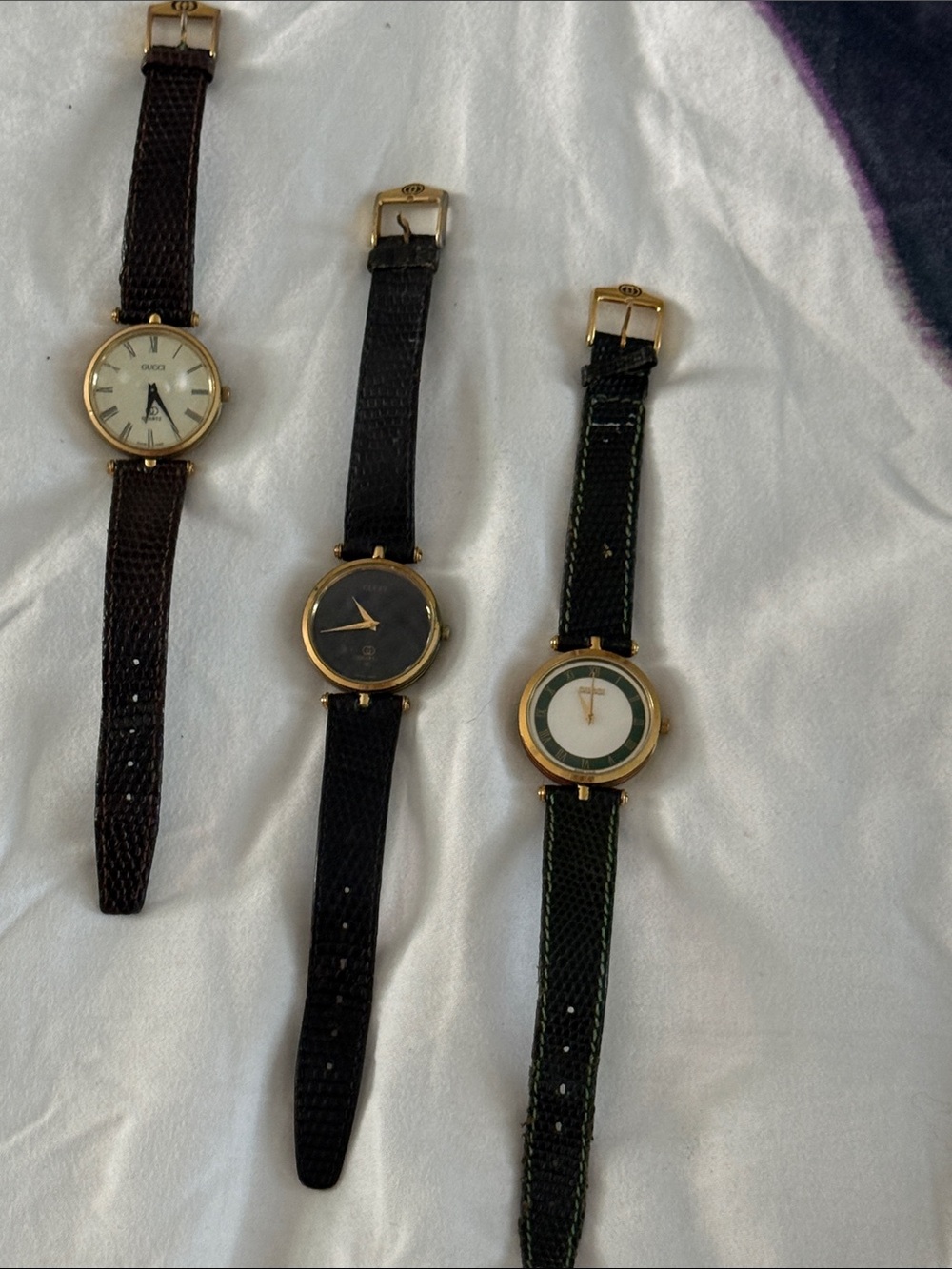 Gucci Trio of Gold-Tone Round Face Watches with Brown, Black and Green Straps